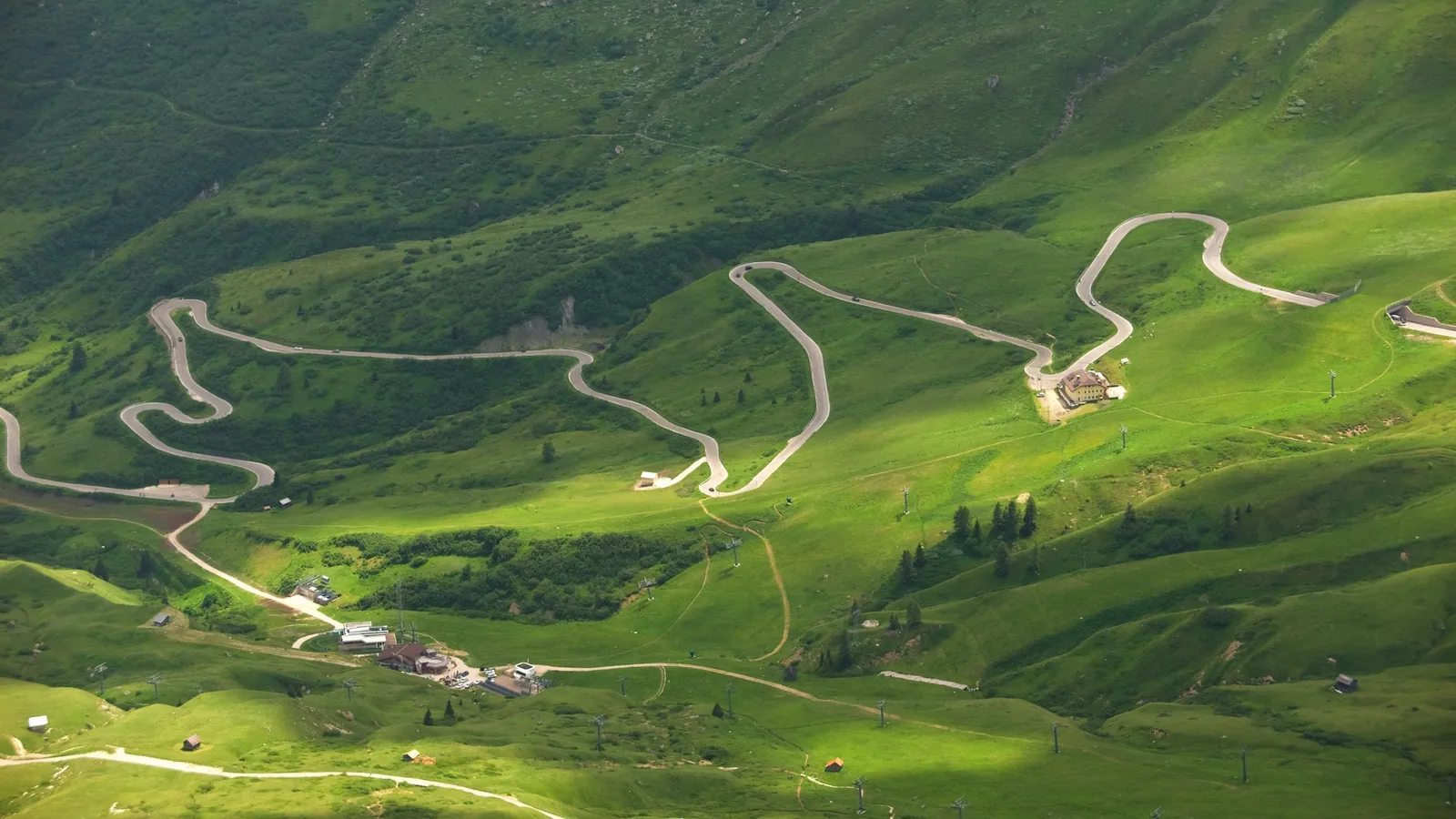 Hairpins below the pink Sella towers on the Pordoi Pass