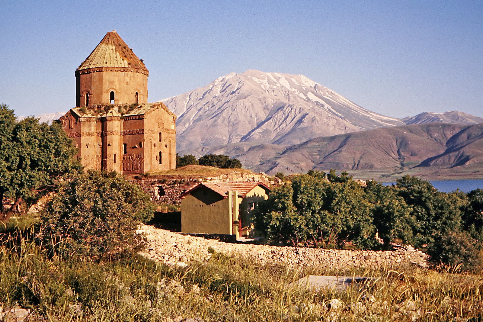 The Church of the Holy Cross on Akdamar island with mountains across Lake Van