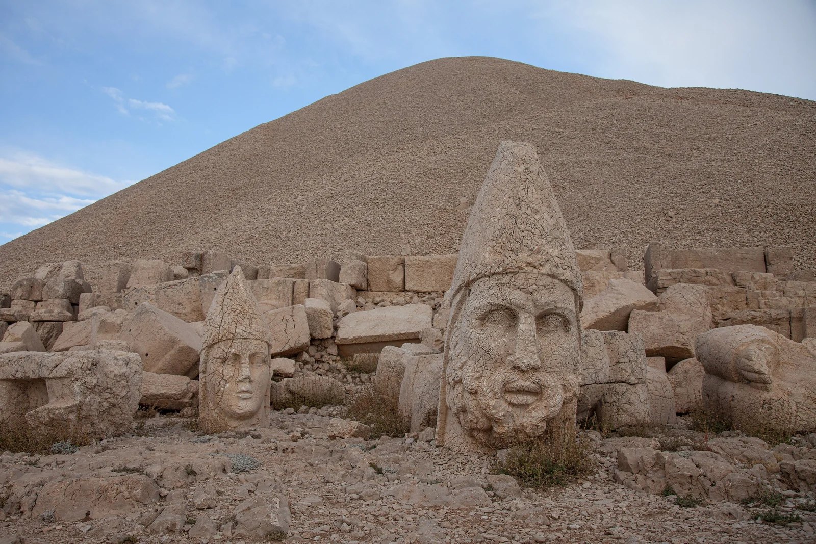 Toppled colossal stone heads below the summit tumulus of Mount Nemrut