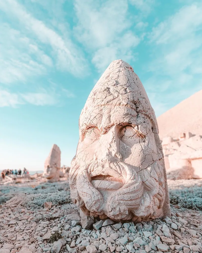 Colossal toppled stone heads on Mount Nemrut at sunrise