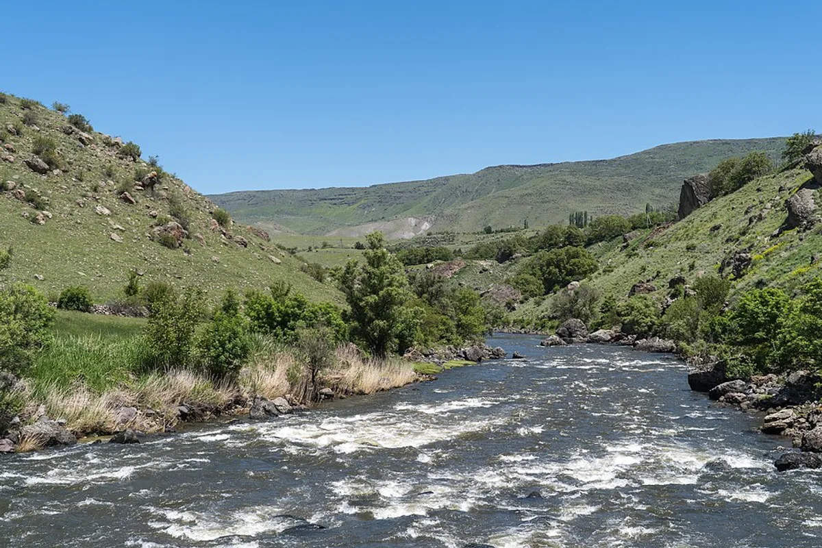The Mtkvari river running through a green valley in southern Georgia near Vardzia