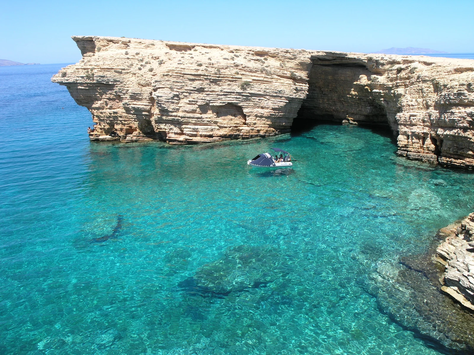 A turquoise bay below pale rock cliffs on Koufonisia