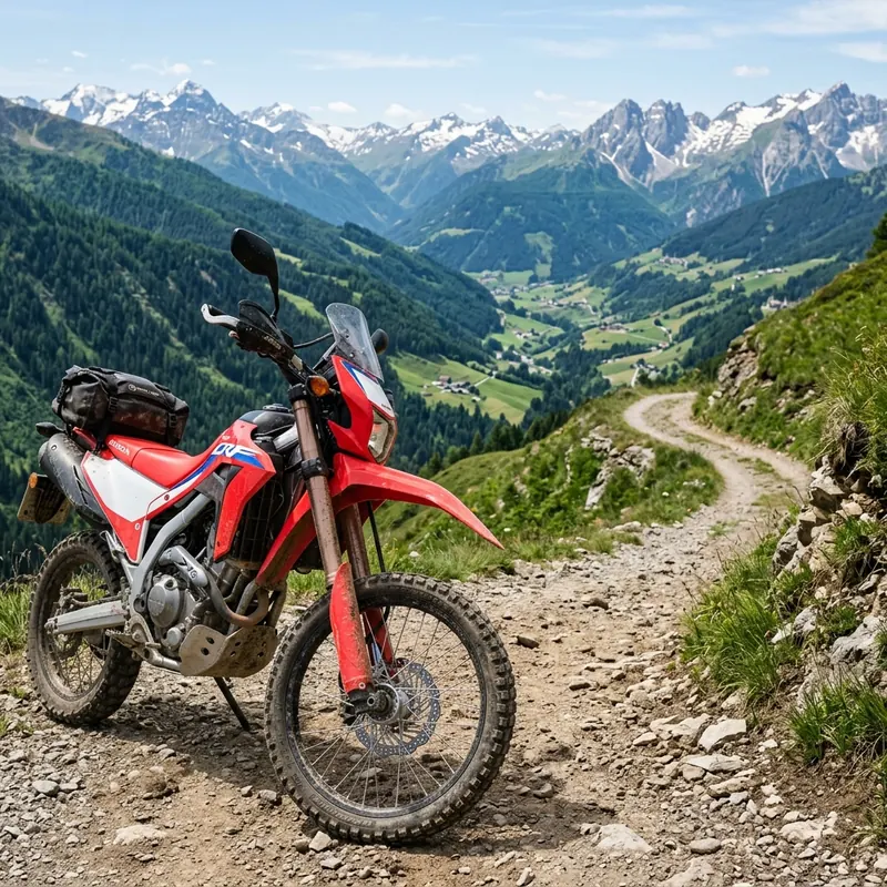 An adventure motorcycle parked on a dirt track overlooking scenic European mountains on the Trans Euro Trail